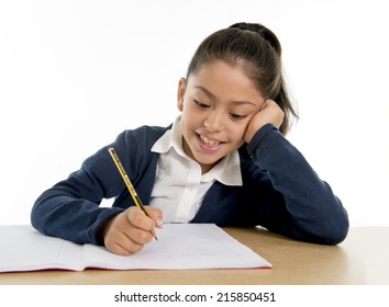 Happy Sweet Little Hispanic Female Child Writing Homework With Pencil Smiling In Children Education And Back To School Concept Isolated On White Background