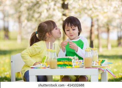 Happy Sweet Preschool Children, Friends And Relatives, Celebrating Fifth Birthday Of Cute Boy, Outdoor In Blooming Apple Tree Garden, Springtime, Late Afternoon