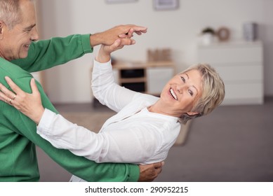 Happy Sweet Senior Couple Dancing Slow Ballroom Dance Inside the House During their Leisure Time.