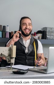 Happy Tailor Shop Owner Checking Monthly Reports, Bills And Expenses Of His Small Business.  Small Entrepreneurship