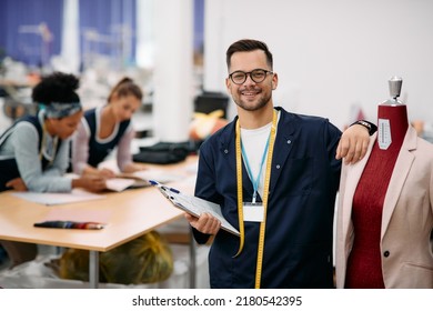 Happy Tailor Working At Clothing Design Studio And Looking At Camera. 