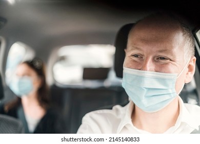 A Happy Taxi Driver Wearing A Mask And The Passenger On The Back Seat Of The Car