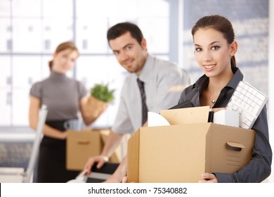 Happy Team Of Businesspeople Moving Office, Packing Boxes, Smiling.?