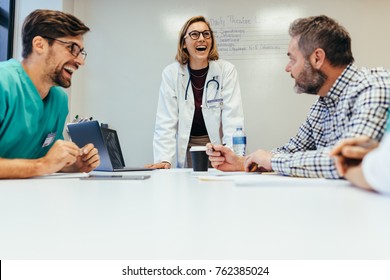 Happy Team Of Healthcare Professionals Smiling During Meeting. Staff Meeting In Hospital.