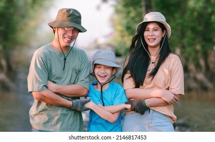 Happy Teamwork of asian family environment conservation volunteer holding hands together for volunteer working help to pick up garbage on forest area.Volunteering save world concept. - Powered by Shutterstock