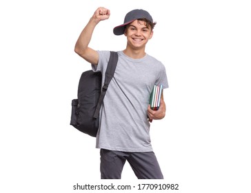 Happy Teen Boy With Books And Backpack, Isolated On White Background. Cheerful Child With Cap Making Greeting Gesture. Emotional Portrait Of Teenager Guy Back To School.