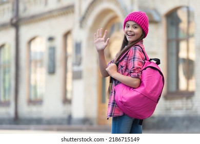 Happy Teen Girl Back-to-school Waving Hand Making Hello Or Goodbye Outdoors, Copy Space