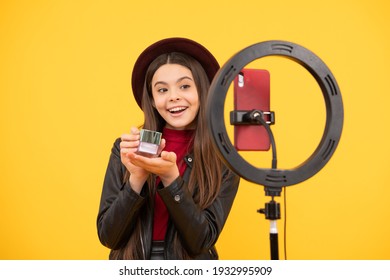 Happy Teen Girl Blogger Use Selfie Led Lamp And Smartphone On Tripod For Making Online Video Tutorial Beauty Blog Presenting Makeup Cosmetics, Beauty.