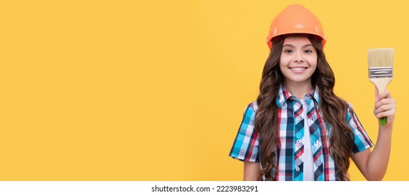 Happy Teen Girl With Curly Hair In Construction Helmet Hold Painting Brush, Painting. Child Builder In Helmet Horizontal Poster Design. Banner Header, Copy Space.