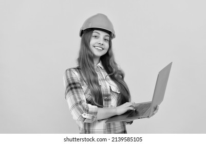 Happy Teen Girl In Helmet And Checkered Shirt Using Laptop, Education Online