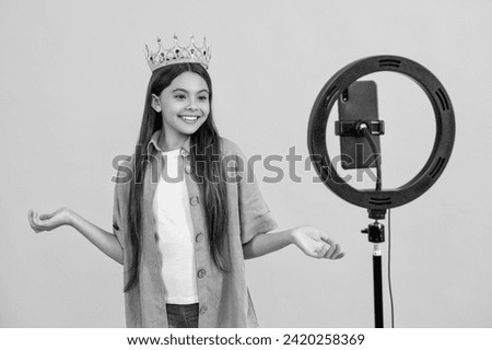 happy teen girl influencer with crown isolated on yellow. teen girl influencer with crown in studio.