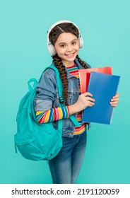 Happy Teen Girl Listening To Audio Lesson. Teenager Listening To Audiobook In Headphones