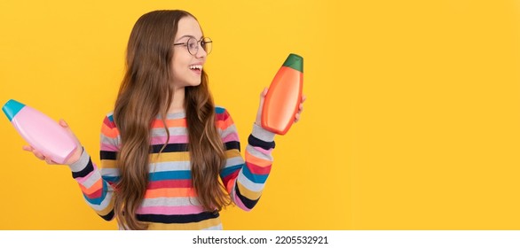 Happy Teen Girl Use Shampoo Bottle. Child With Hair Conditioner. Daily Habits And Personal Care. Banner Of Child Girl Hair Care, Studio Poster Header With Copy Space.