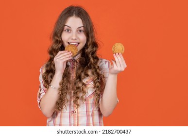 Happy Teen Kid Eat Oatmeal Cookies On Orange Background