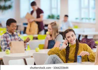 Happy Teen Schoolgirl Talking By Phone At School Cafeteria