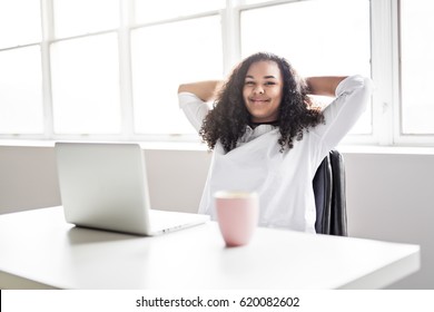 A Happy Teen Taking A Break At Desk In Her Office