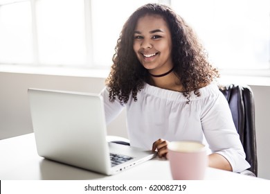 A Happy Teen Taking A Break At Desk In Her Office