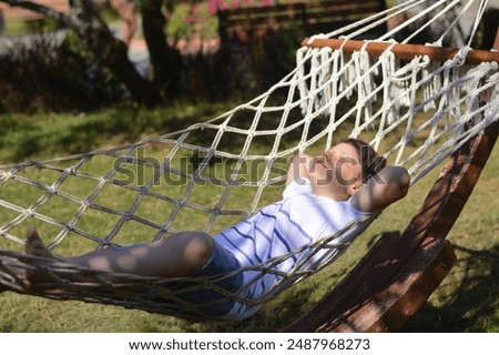 Similar – Young woman relaxing in a hammok