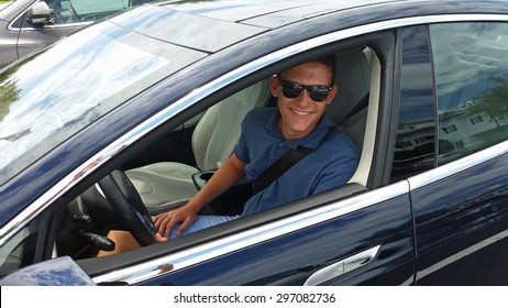 Happy Teenage Driver In A New Tesla Electric Car