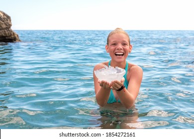 Happy Teenage Girl Caught Large Jellyfish In Water Sea On Beach. Danger Of Burns Or Sting Scyphozoa.