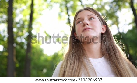 happy teenage girl portrait in the park. teenager wants a dream portrait at sunset. woman daughter silhouette dreams of a happy childhood in the forest park. independence girl teenager concept