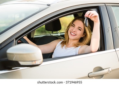 Happy Teenage Girl Showing Keys From Her First Car - Side View