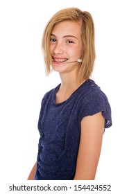 A happy teenage girl wearing corrective headgear for her teeth. - Shutterstock ID 154424552