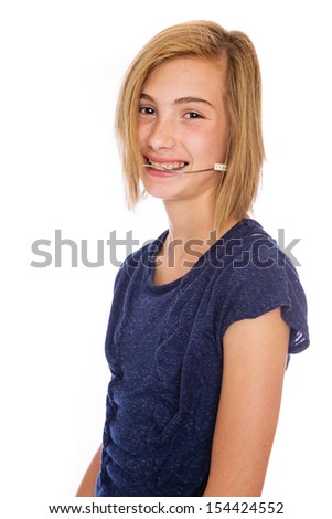 A happy teenage girl wearing corrective headgear for her teeth.