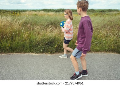 Happy Teenage Siblings Or Friends Joyful Walking At Summer Holidays