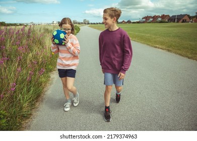 Happy Teenage Siblings Or Friends Joyful Walking At Summer Holidays