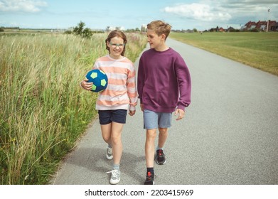 Happy Teenage Siblings Or Friends Joyful Walking At Summer Holidays