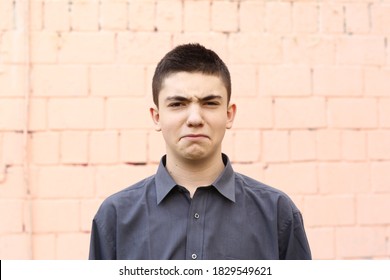 Happy Teenager Boy Grimace Wink Close Up Portrait On White Wall Background