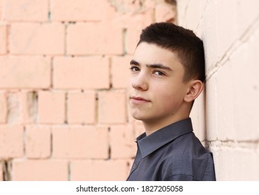 Happy Teenager Boy Wink Close Up Portrait On White Wall Background