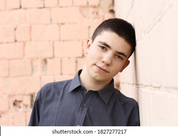 Happy Teenager Boy Wink Close Up Portrait On White Wall Background