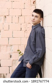 Happy Teenager Boy Wink Close Up Portrait On White Wall Background