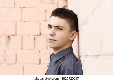 Happy Teenager Boy Wink Closeup Portrait On White Wall Background