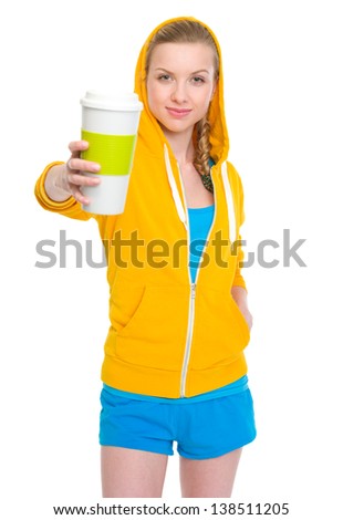 Happy teenager girl giving coffee cup