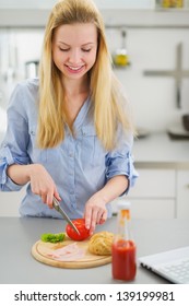 Happy Teenager Girl Making Sandwich In Kitchen