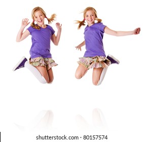 Happy Teenager Girls Identical Twins Jumping And Laughing Of Happiness Having Fun, Isolated.