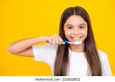 Happy teenager portrait. Teenager girl brushing her teeth over isolated yellow background. Daily hygiene teen child hold toothbrush, morning routine. Dental health oral care. Smiling girl. - Powered by Shutterstock
