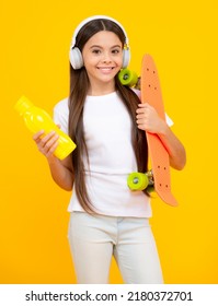 Happy Teenager Portrait. Studio Shot Of Trendy Teenage Fashion Model In Casual Look. Teenager Youth Hipster Urban Lifestyle. Child Girl In Street Style In Hipster Clothes With A Skateboard.