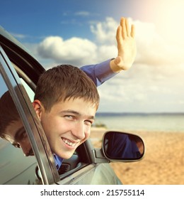 Happy Teenager Sitting In The Car And Wave Goodbye