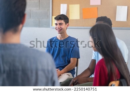 Happy Teenager student talking to classmates - Support Group discussion at School