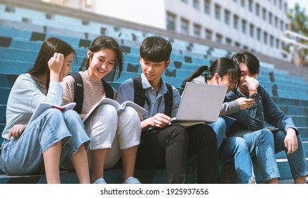 Happy Teenager Students Talking And Sitting On The Stairs 