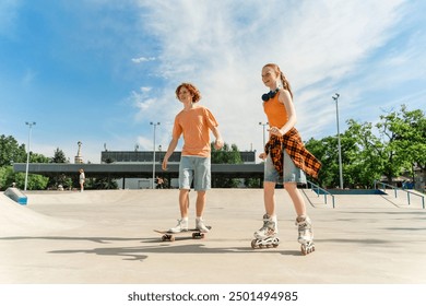 Happy teenagers boy and girl enjoying roller skates and skateboard riding at the skate park. Summer time, lifestyle concept - Powered by Shutterstock