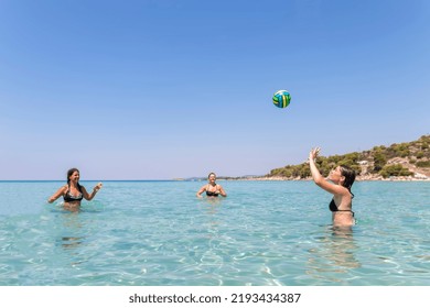 Happy Teenagers  Playing Volleyball In Water At The Beach.Traveling, Vacation And Fun