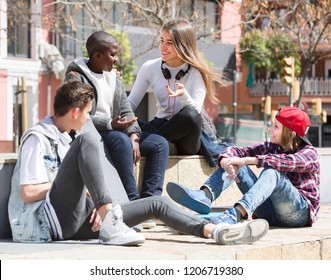 Happy Teens Spending Time Together And Talking In Sunny Day In Square