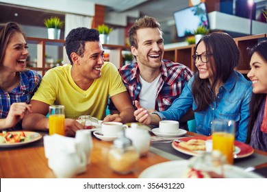 Happy Teens Talking During Lunch In Cafe