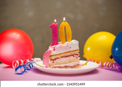 Happy Tenth Birthday Cake And Pink Number Ten Candles With Balloons And Party Decor, Anniversary Concept