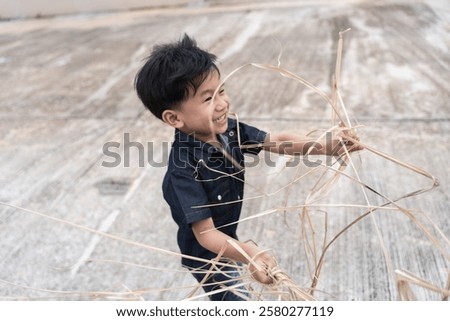 Similar – Image, Stock Photo Child laughing joyfully while making a snow angel, dressed in a vibrant winter coat and hat